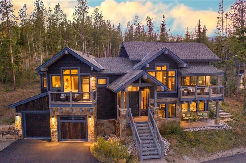 Large illuminated mountain house at dusk